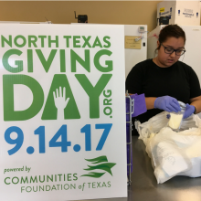 Employee checking pump dates on bags of donated breastmilk