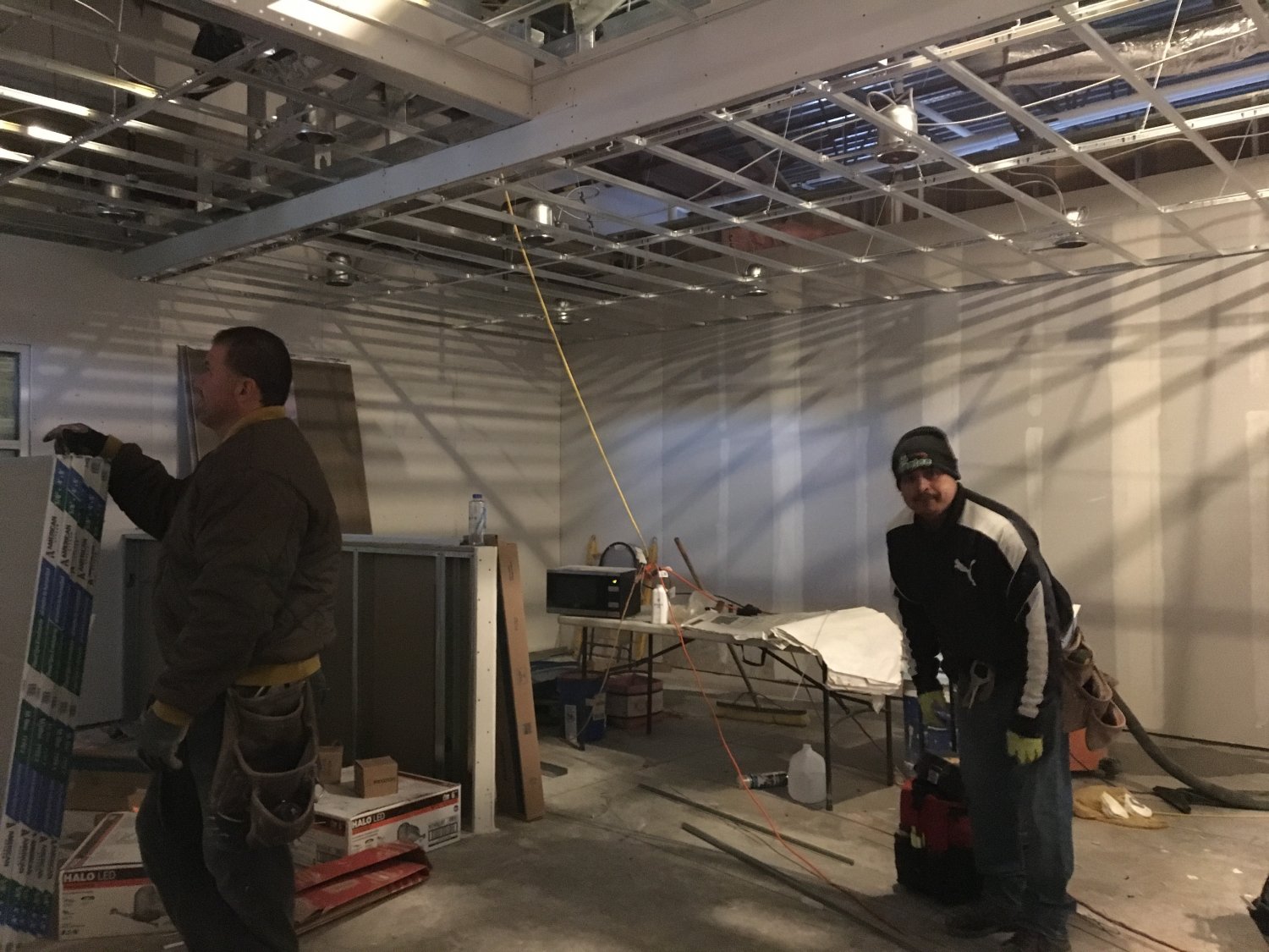 Two men standing in indoor construction site