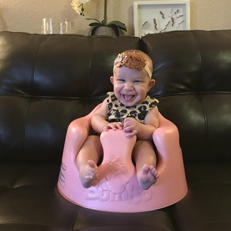 Baby sitting in bumbo seat