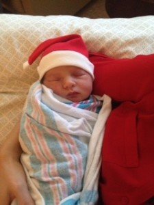 Newborn baby wearing a Santa hat