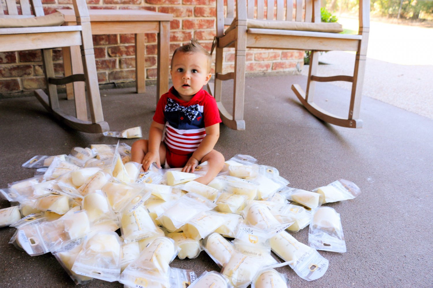 Baby sitting among frozen milk bags