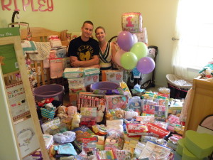 Crystal and Zack with the results of a NICU fundraiser, commemorating Ripley's first birthday.