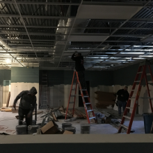 Three men working at indoor construction site