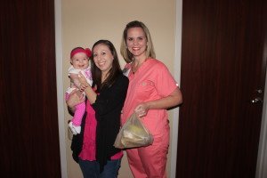 Mom Amanda and daughter Reagan drop off one of the first donations at Methodist Mansfield, accepted by Mandi Longoria.