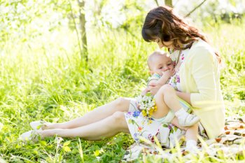 Mother breastfeeding baby outdoors