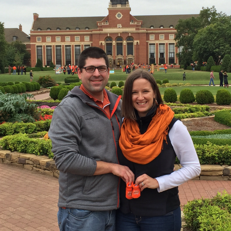 Couple holding baby booties