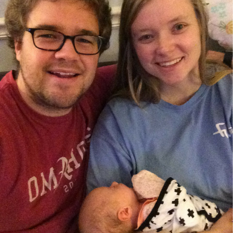 Mother and father holding premature daughter