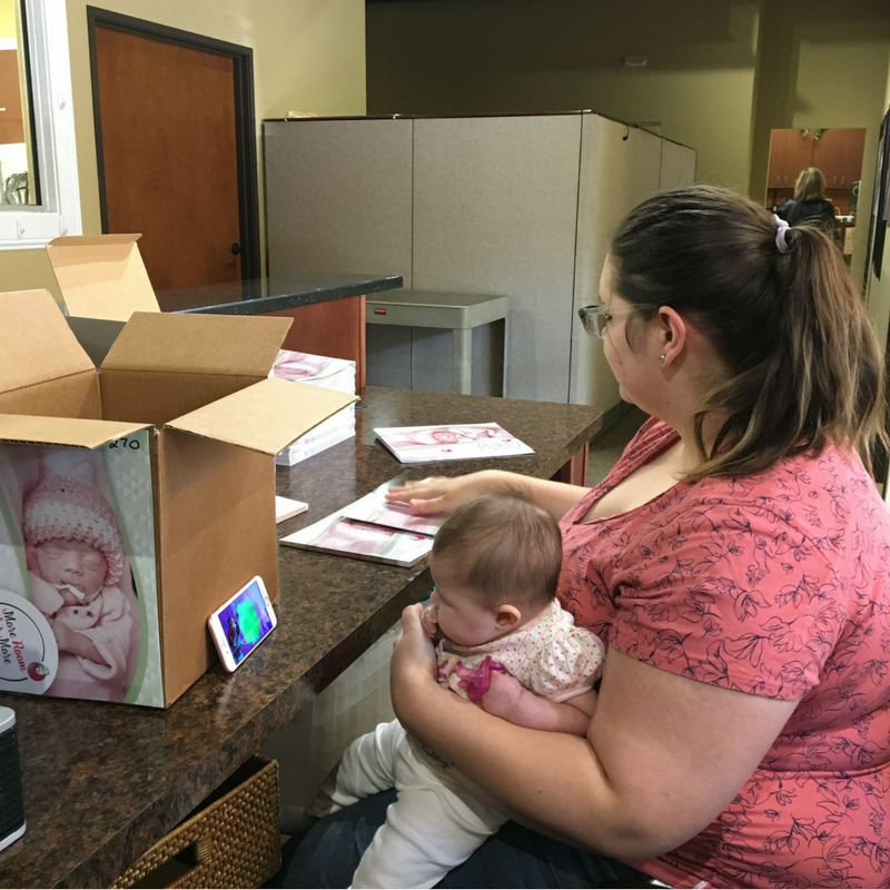 Mother at office, holding baby