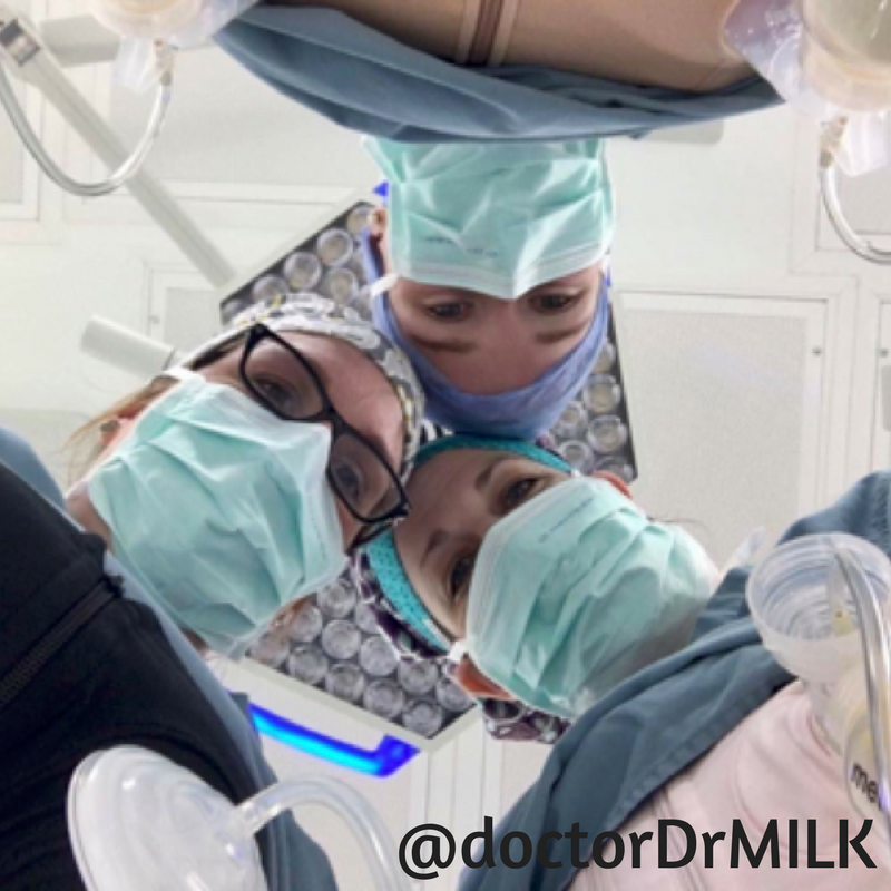 Three surgeons, all pumping milk, looking down at the camera