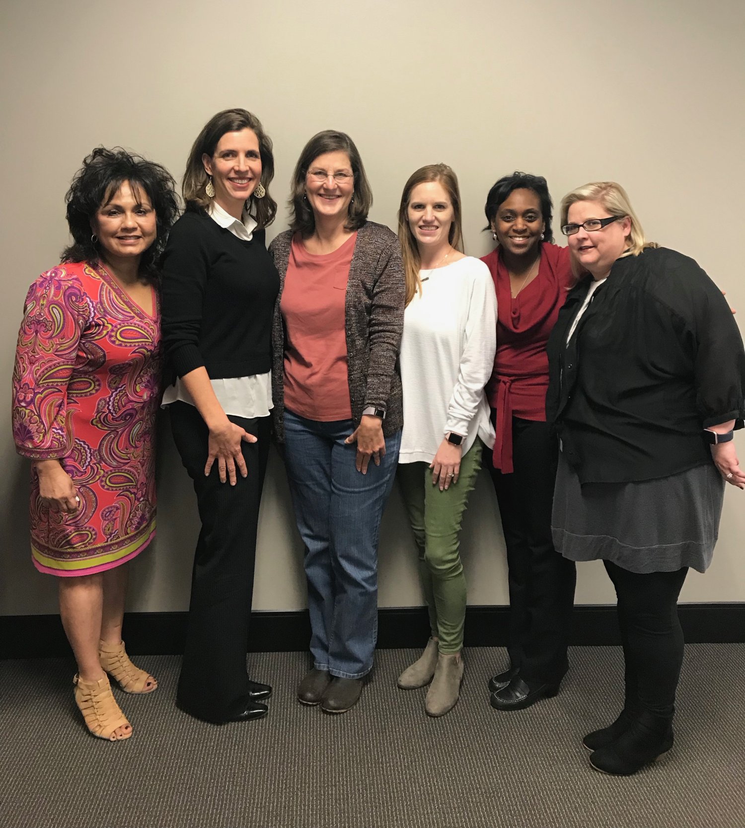 Six women standing side by side