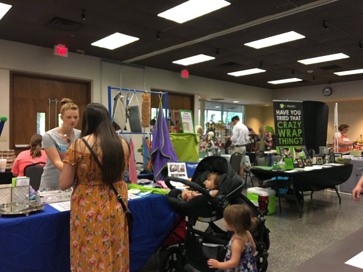 Women discussing products at a vendor booth