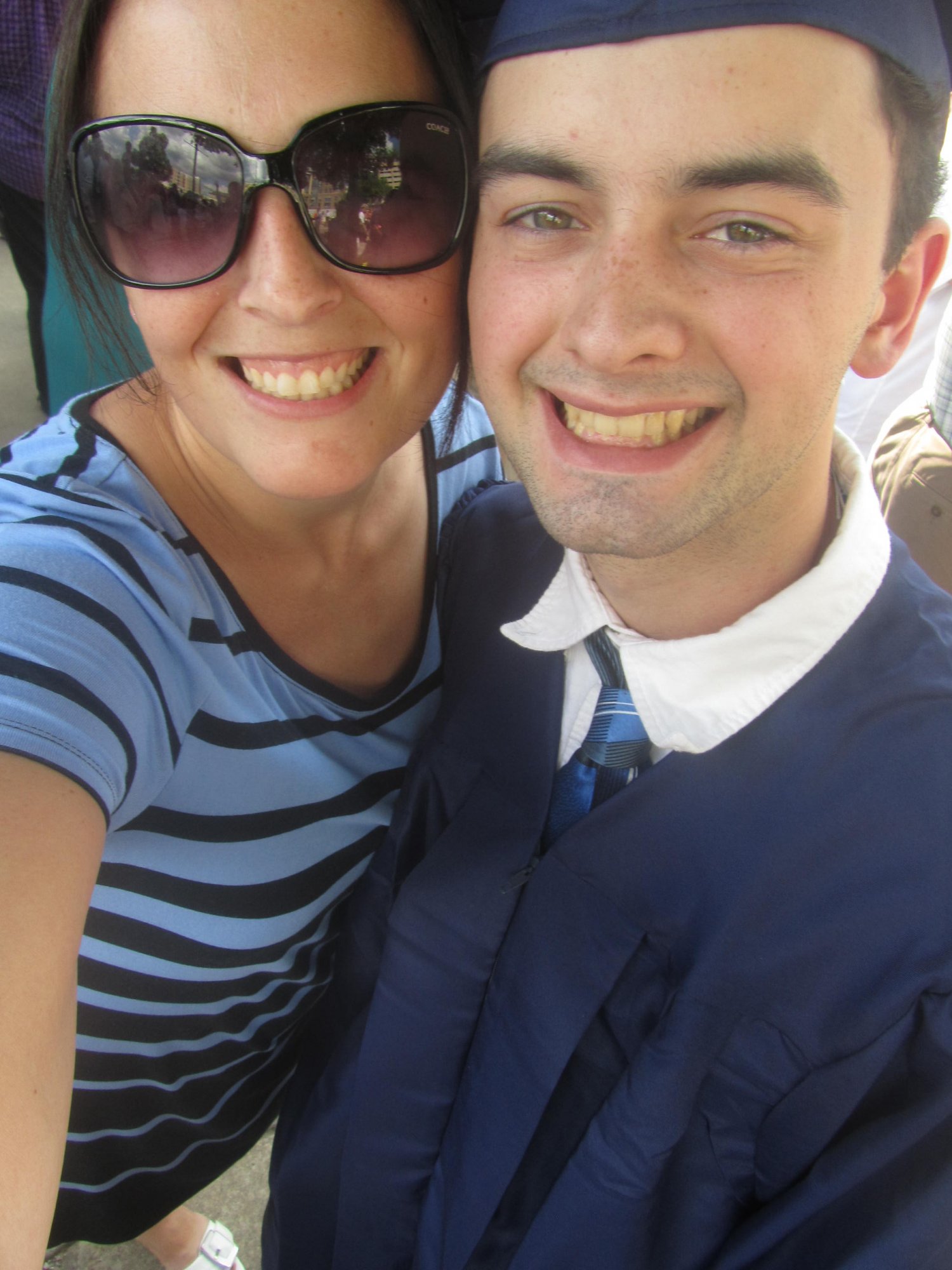 Mother with son in high school graduation cap and gown