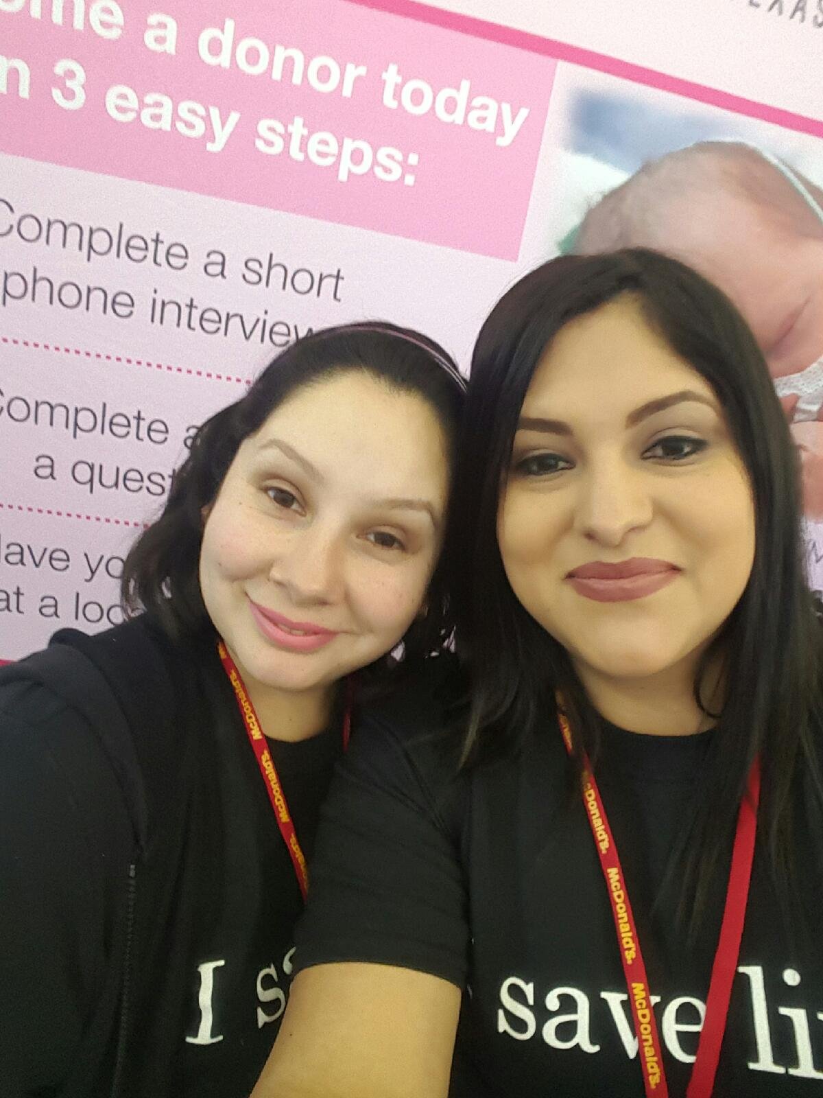 Two women standing in front of the milk bank display