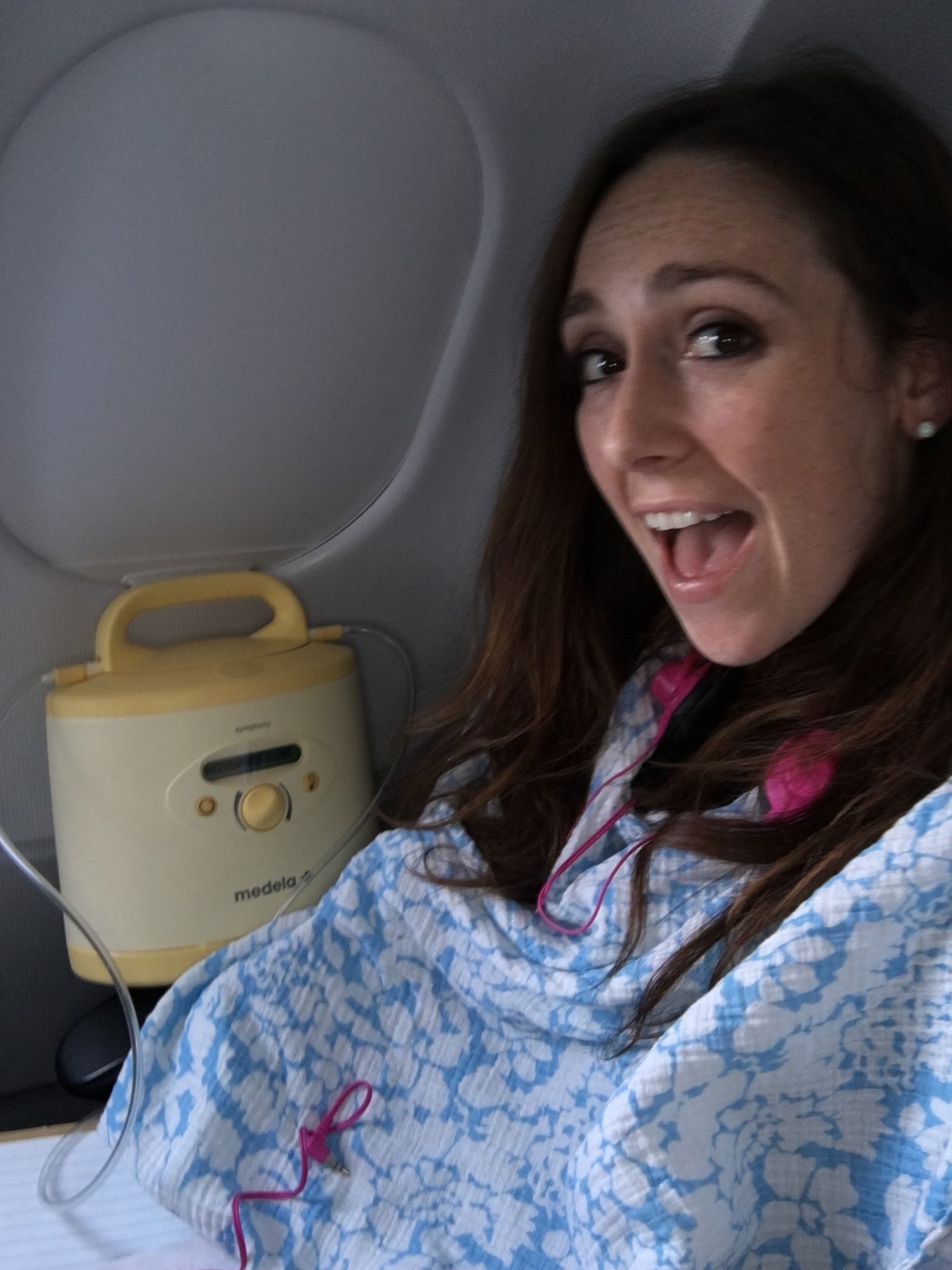 Woman using breast pump while on airplane