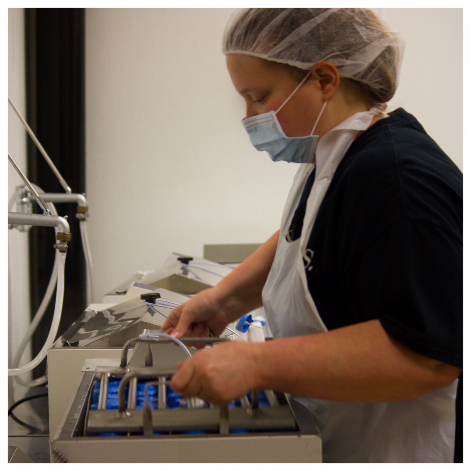 Lab technician removing breastmilk bottles from pasteurizer