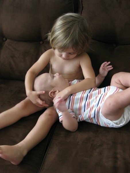 Toddler holding baby brother