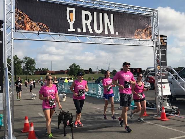 5 people and 1 dog crossing a race finish line