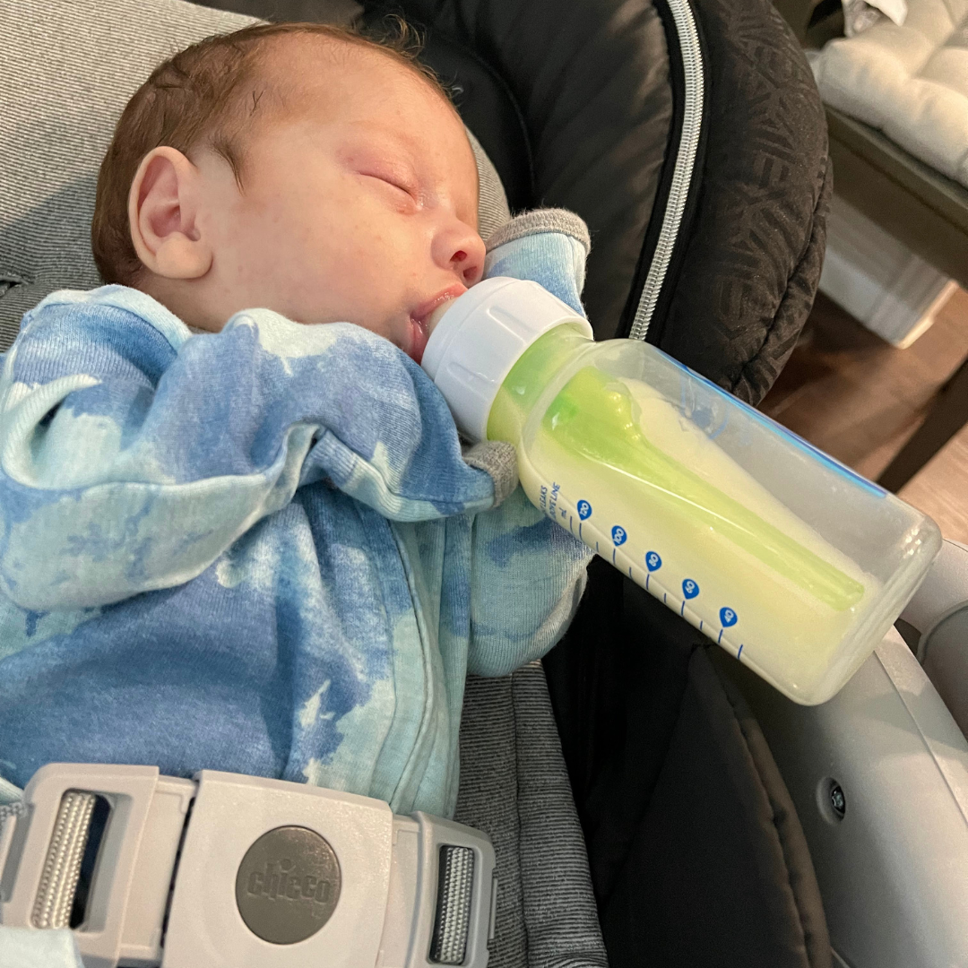Caio's first day at home with 4oz bottle of donor milk, about half as big as his body