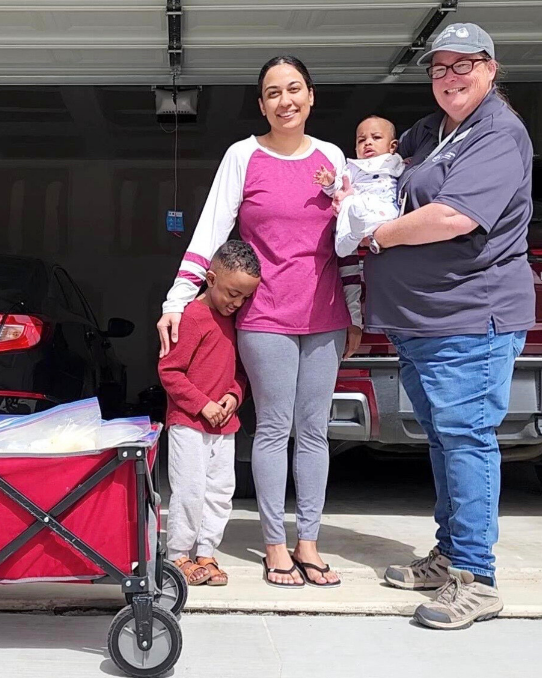 Milk pick-up day: Saira, a wagon full of frozen milk, her boys and milk bank courier Donna