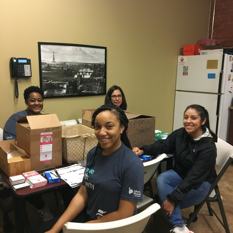 Four volunteers sitting at a table