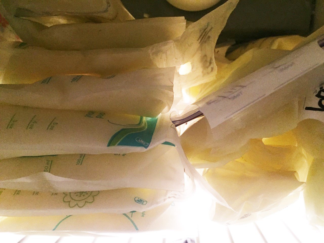 Breastmilk bags arranged in freezer