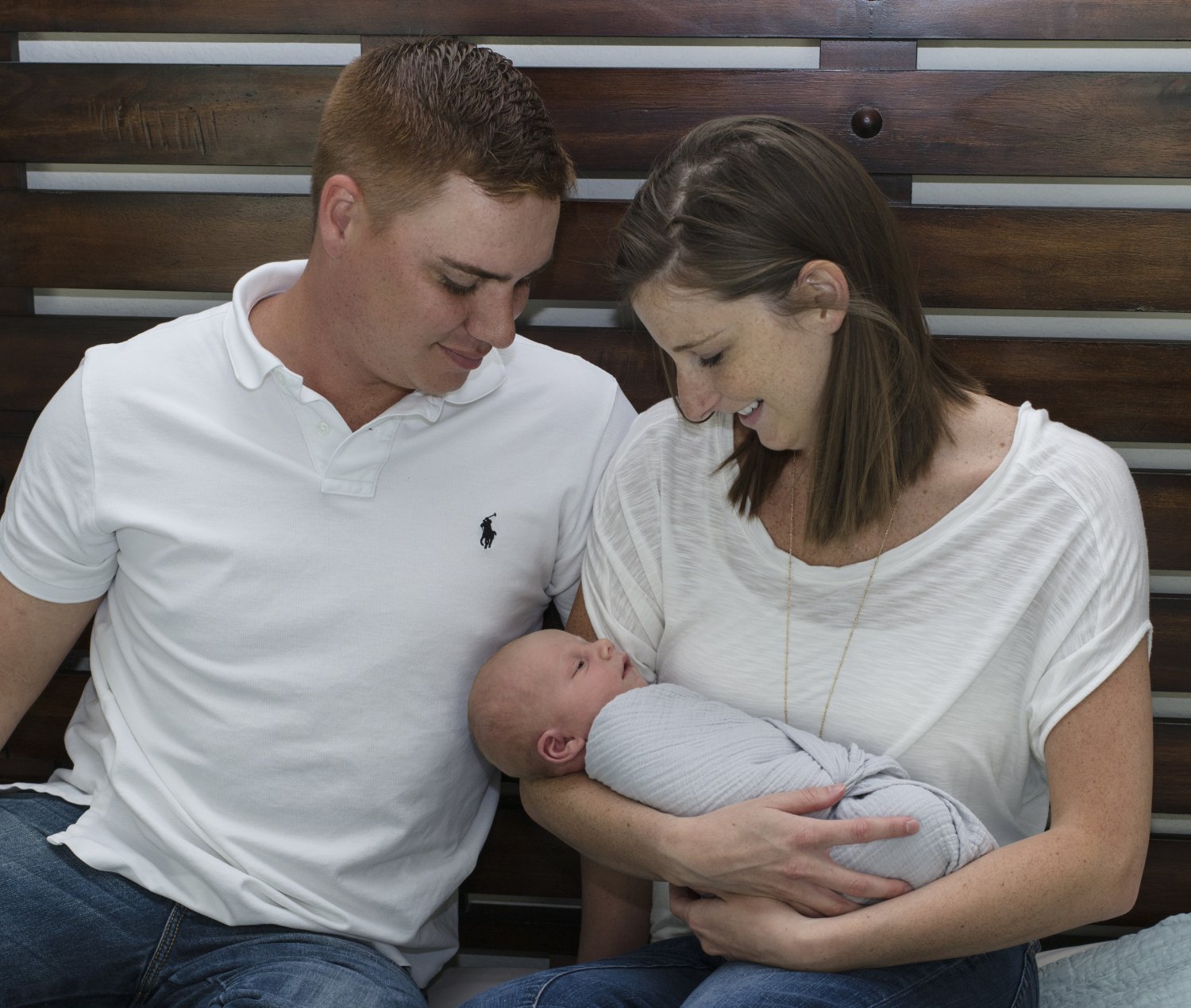 Mother and father holding newborn son