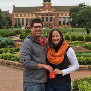 Couple holding baby shoes