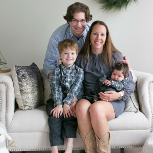 Mother, father, young son and infant son on a couch