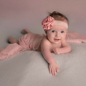 Baby girl on photo backdrop